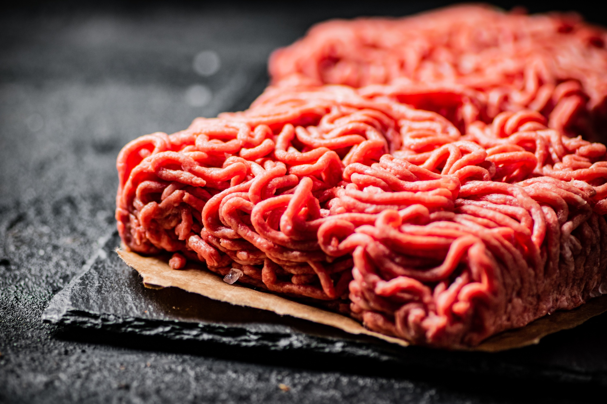 Raw minced meat on a stone board.